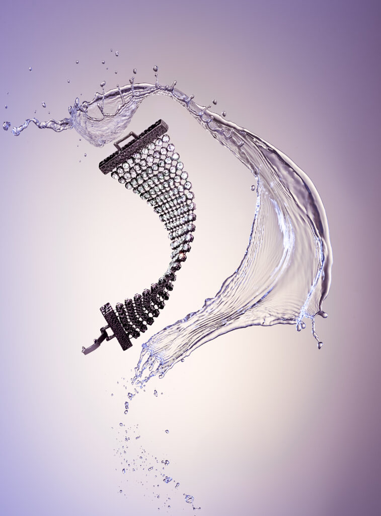 a baracelet with diamonds , motion with a water splash